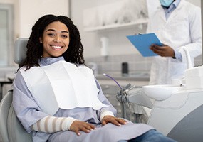 Woman smiling while sitting in treatment chair