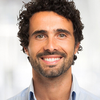 close-up of man in a collared shirt smiling