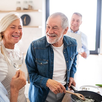 older couple cooking and smiling