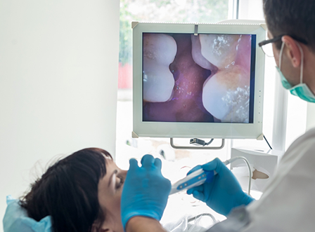 Checking patient's smile with intraoral camera