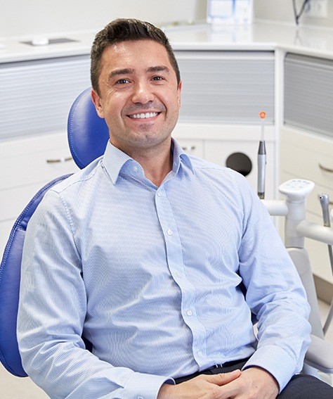 Man smiling in dental chair thanks to sedation dentistry in Austin