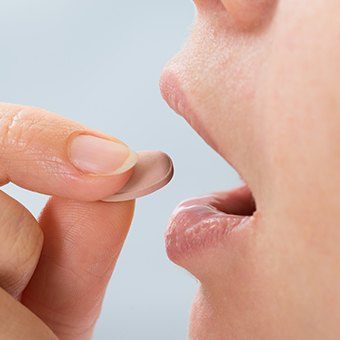 Close up of a person about to take a pill