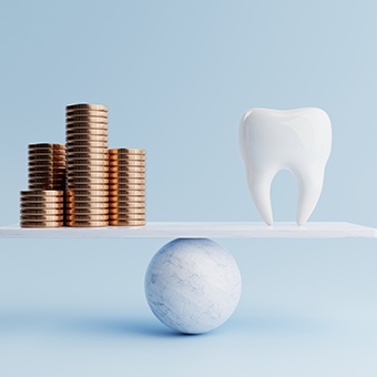 Model tooth on a simple ball and plank scale with a pile of coins